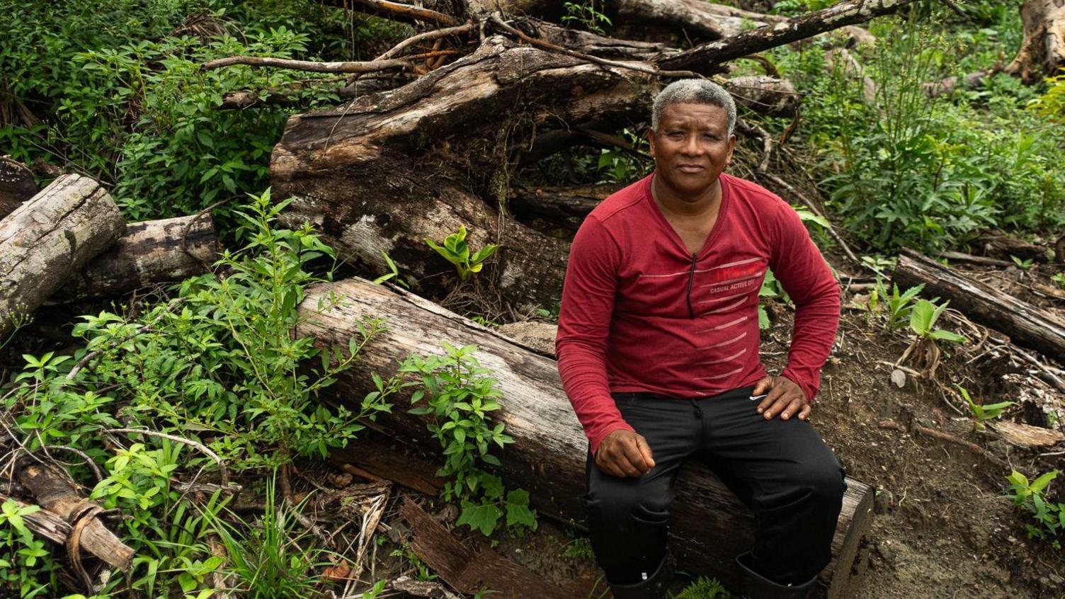 Claudio Verequete Sitting on a Felled Tree (Source: BBC / Paulo Koba)